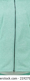 Green Fabric With Metal Zipper. Texture Of Green Jersey. Vertical Background.