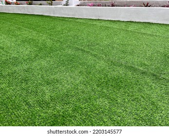 Green Fake Grass Installation In Selective Focus. 