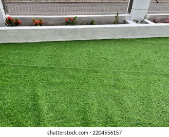 Green Fake Grass Installation In Selective Focus. 