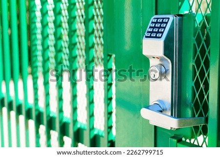 Green fence gate entry lock with keypad, side view