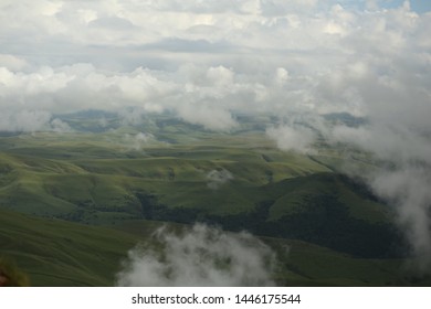 Green fields and hills under the clouds