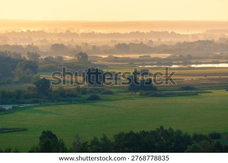 Green fields and meadows with trees and river at pink foggy sunrise. Beautiful summer landscape. Yelabuga, Tatarstan, Russia