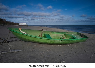 Green fishing boats by the sea on a sunny day