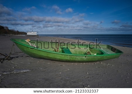 Green fishing boats by the sea on a sunny day