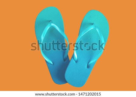 Green flip flops isolated on orange background. Top view