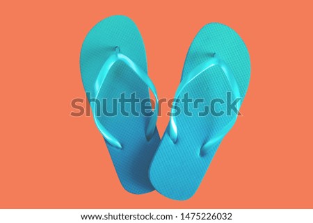 Green flip flops isolated on red background. Top view