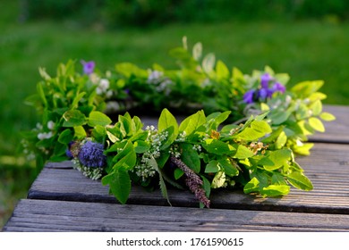 Green, flower wreath on wooden boards