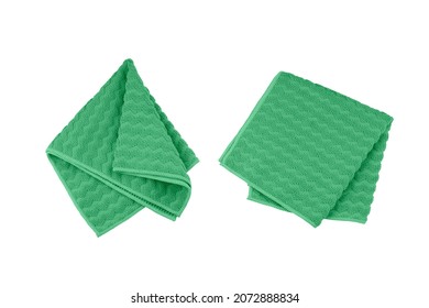 Green folded microfiber towel set isolated on white background, top view.
