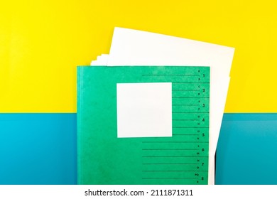 Green Folder with empty sticky note message, text paper note with Documents and abstract yellow blue paper Background. copy space. blank message text template