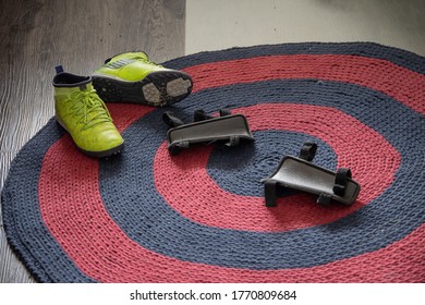 Green Football Boots And Protectors On The Carpet