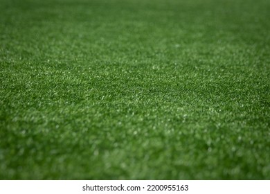 Green Football Grass Background. Focus In The Center And Blurry Sides For Copy Space. Soccer Stadium Field.