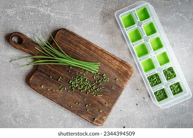 Green fresh organic chives on wooden cutting board ready to freeze. Overhead shot. - Powered by Shutterstock