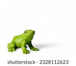 Green frog plastic animal toy on white background