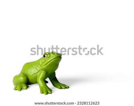 Green frog plastic animal toy on white background