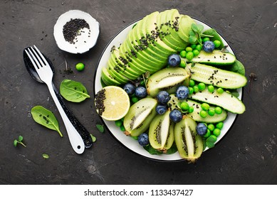 Green Fruit Vegetables Summer Detox Bowl Of Salad. Avocado, Spinach, Cucumber, Micro Greens, Blueberries One Plate Dish. Top View