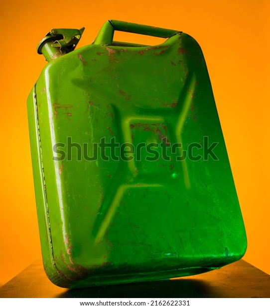 green fuel container\
on colorful bright backgrounds isolated close-up with blank space\
for title and text