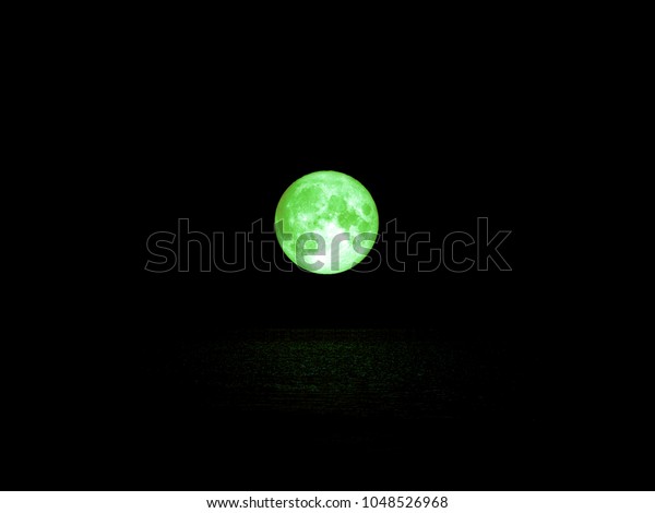green full moon and light\
reflection on water surface, Elements of this image furnished by\
NASA