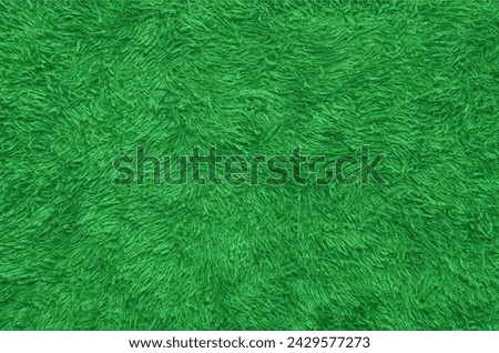 Green fur texture top view. Green sheepskin background. Fur pattern