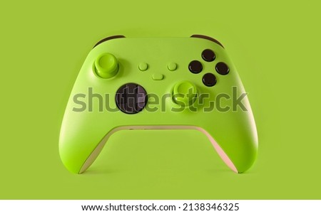 Green game controller on green background