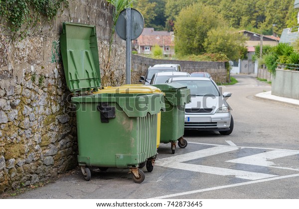 green garbage cans on the
street