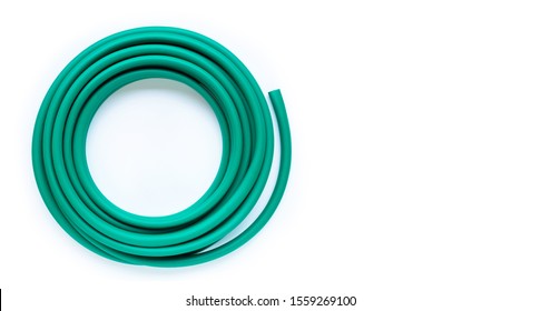 Green Garden Hose On White Background. Copy Space