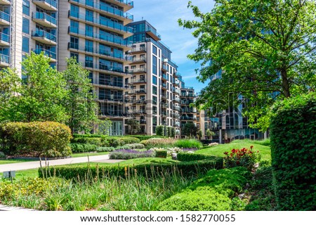 Green garden within apartment building complex in Battersea Reach during summer time.
