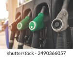 Green Gas Pump Nozzles at Service Station