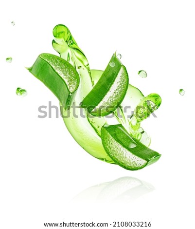 Green gel flowing with aloe vera slices isolated on white background with clipping path.