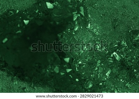 Green geode interior with rough texture and crystal facets.