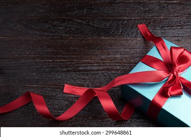 green gift box red bow on wood table, top view - Powered by Shutterstock