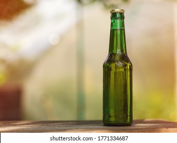 Green Glass Bottle Of Cold Beer Outside In Summer