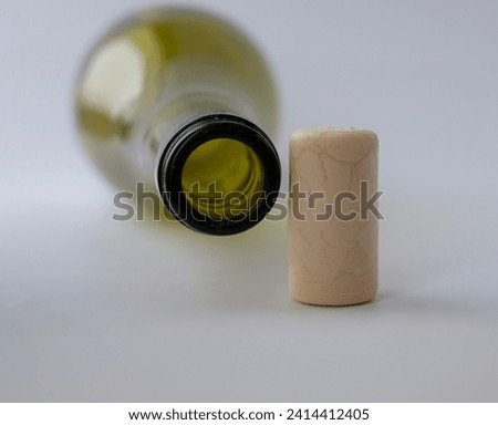 Green glass bottle neck. Synthetic wine cork.