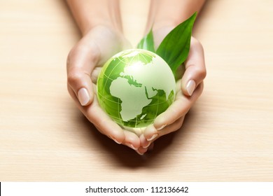 Green Glass Globe In Hands