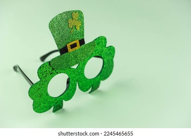 Green glasses with shamrock for Saint St Patrick’s day holiday celebration on green background. Funny sparkle eyeglasses, happy St Patricks day concept. - Powered by Shutterstock