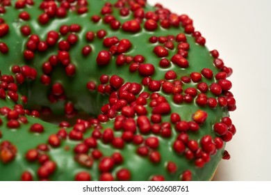 Green glazed round donut isolated on white background. Side view. High quality photo
