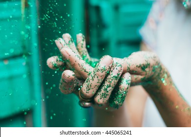 Green glitter on woman hands