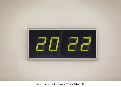 Green glowing digital clocks in the dark show 20:22 time