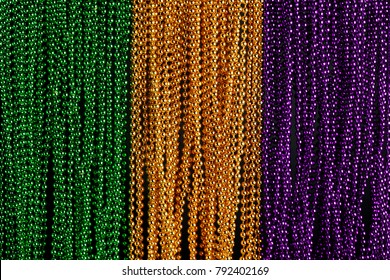 Green, Gold, And Purple Mardi Gras Beads Background