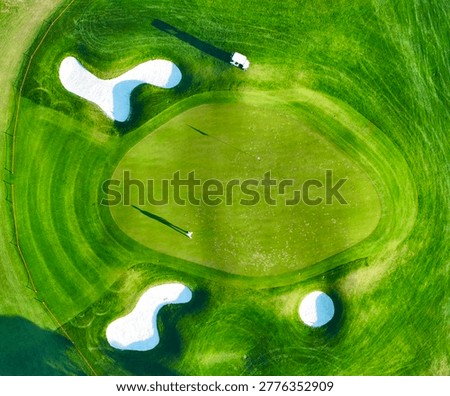 green golf course and shadows