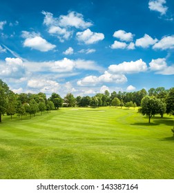 Green Golf Field And Blue Cloudy Sky. European Landscape