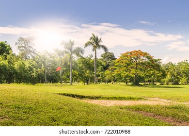 Green Golf Field Par 3 And Blue Cloudy Sky.