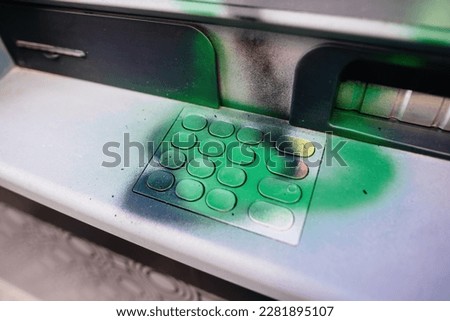 Green graffiti on the keyboard of an ATm of an international bank after a strike against pension reform Proposed by french President