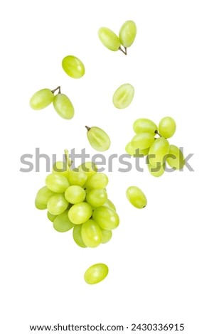 Green grapes flying in the air isolated on white background.