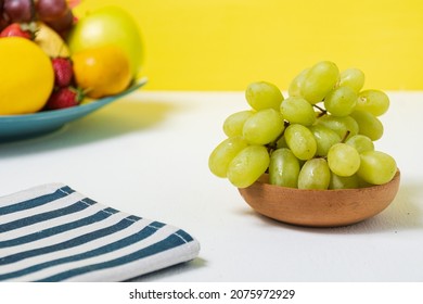 green grapes with plate full of fruit. Whitespace Background