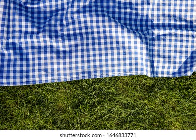 Green grass blue checked picnic cloth blanket top view background - Powered by Shutterstock