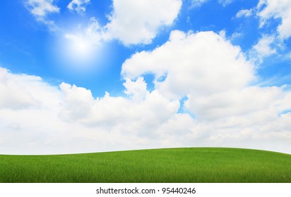 green grass with blue sky and sunshine - Shutterstock ID 95440246