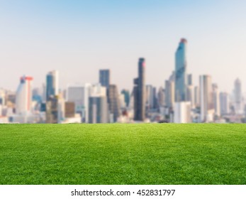 green grass with cityscape background - Shutterstock ID 452831797