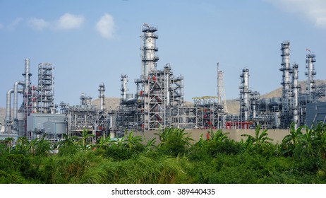 Green Grass Field And Oil Refinery Factory Plant Or Petrochamical And Power.