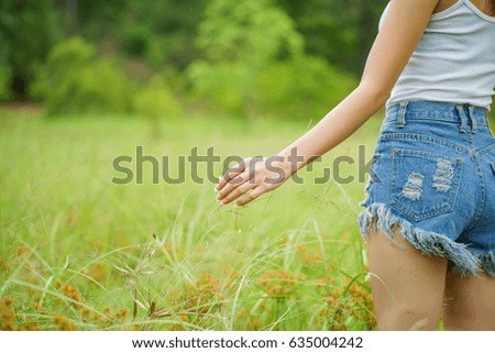 green grass and girl's hand