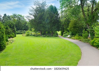 Green Grass In Meadow And Footpath In Picturesque Summer Park.